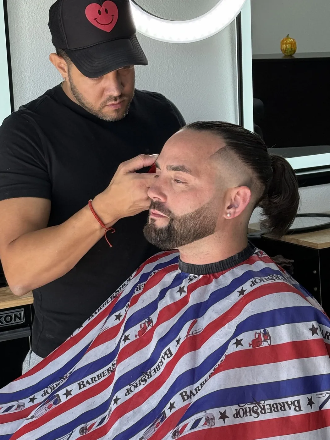 Barber trimming a client's hair with clippers